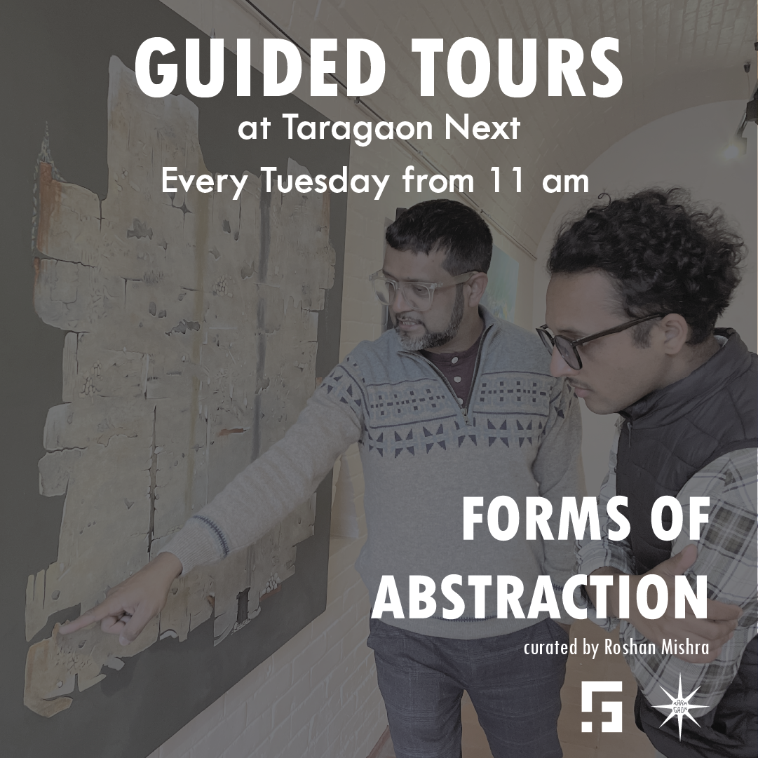 Two people are looking at an artwork, pointing at a particular spot